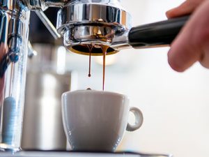 Close up of a barista machine pouring coffee into a mug