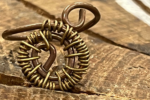 Wire Bead ring on a wooden surface
